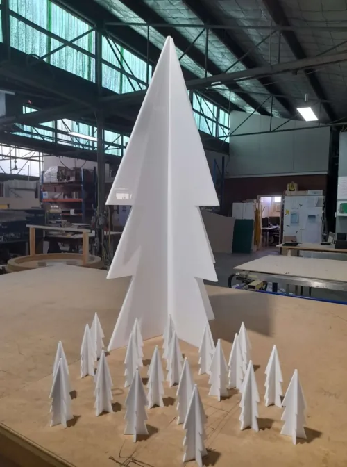 a group of white paper trees sitting on top of a table.