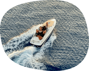 a small boat traveling through the ocean on a sunny day.