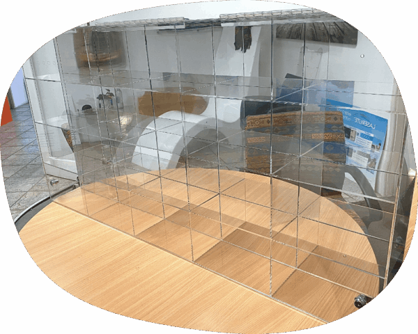 a clear plastic shelf on top of a wooden table.