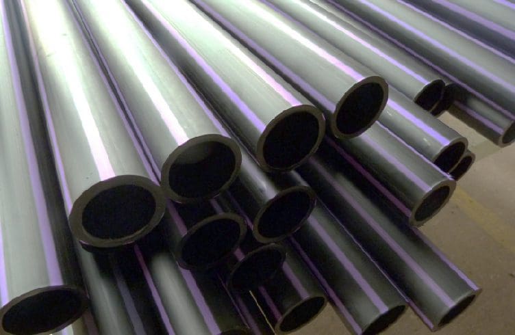 a bunch of pipes are lined up on the floor.