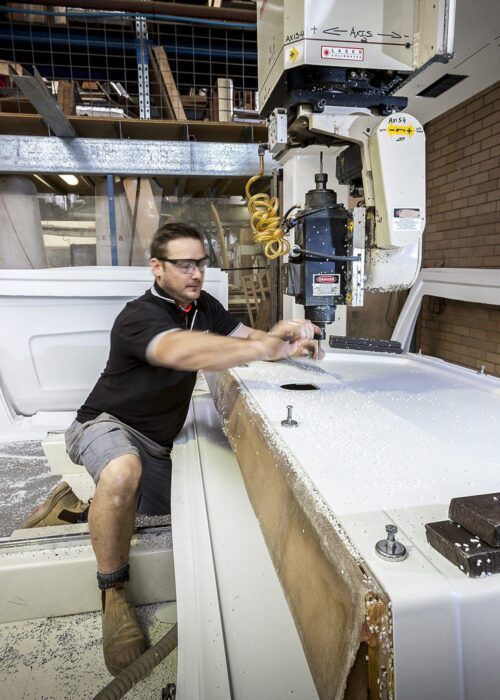 a man working on a machine in a factory.