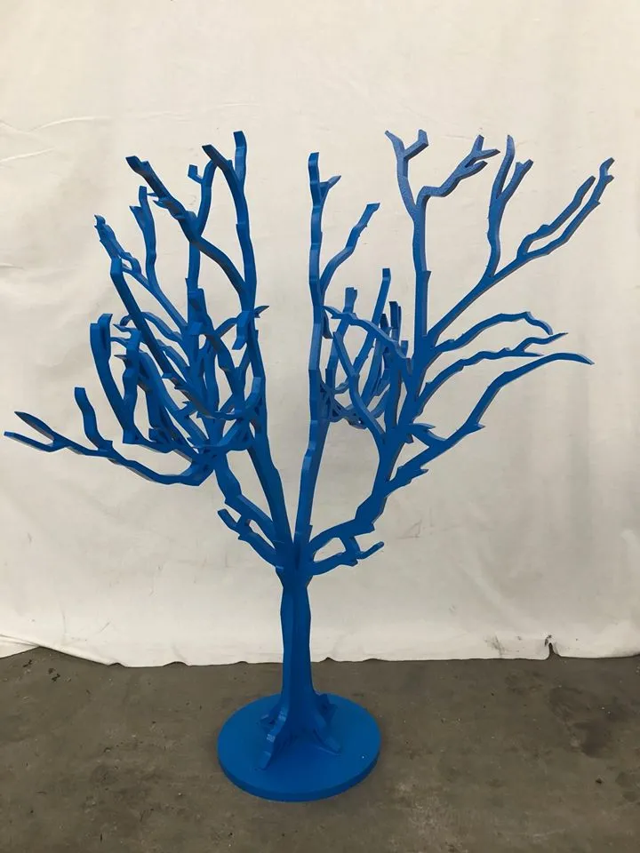 a blue sculpture of a tree on a blue pedestal.