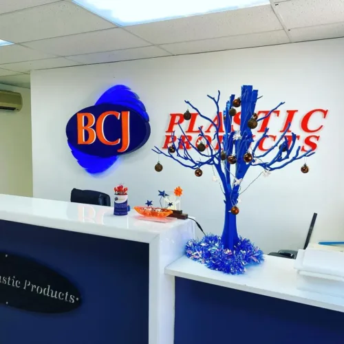 a branch of a tree in front of a sign.