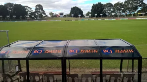 a row of chairs sitting in front of a metal structure.