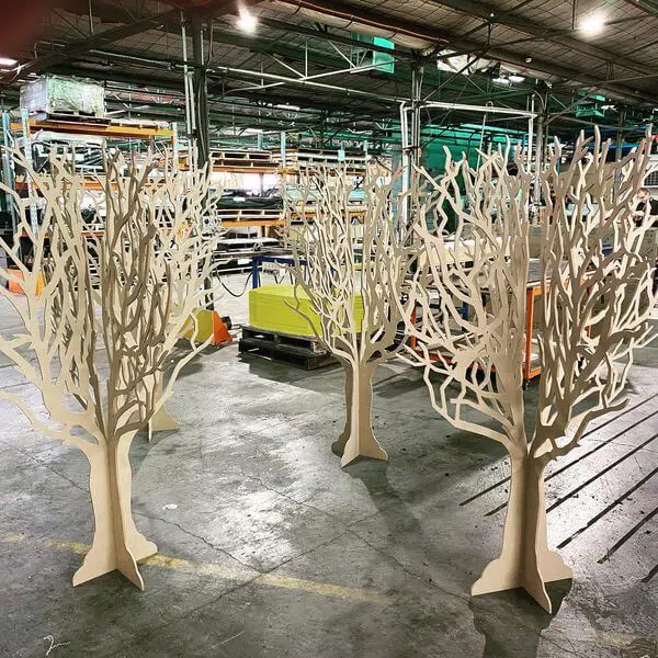a group of wooden trees in a warehouse.