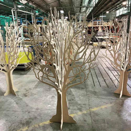 a group of wooden trees sitting on top of a floor.