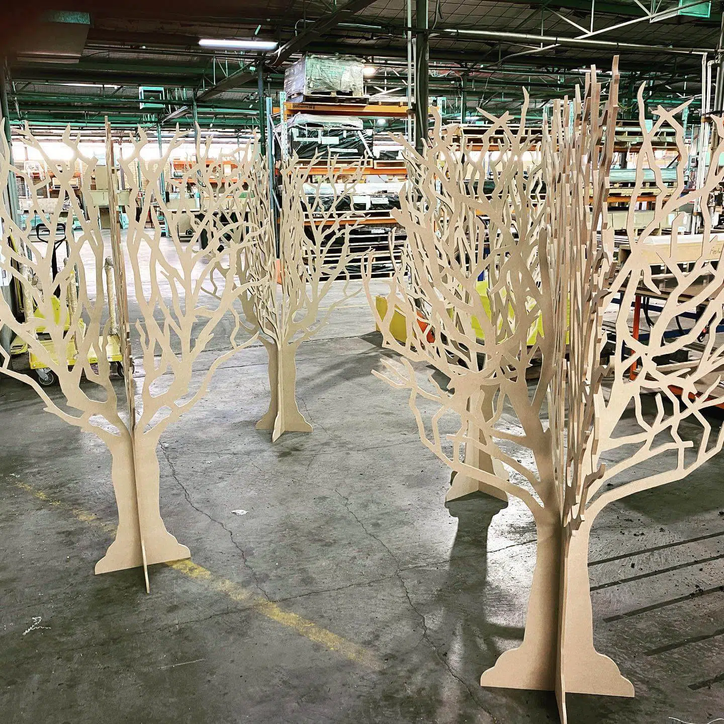 a group of wooden trees in a warehouse.