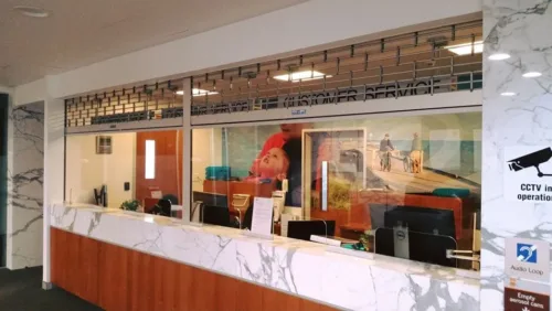 an office with marble counter tops and a painting on the wall.