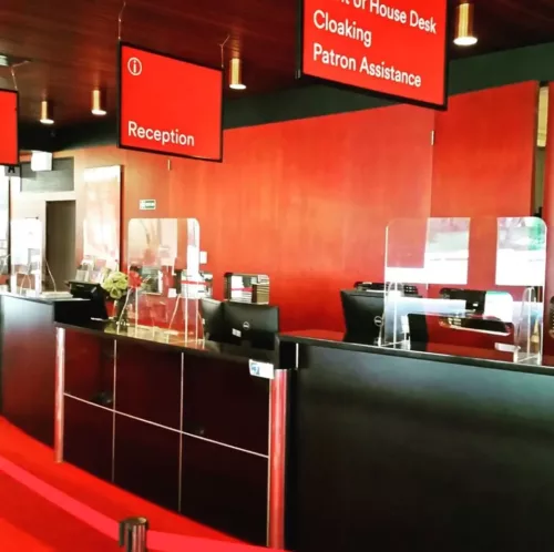 a restaurant with red walls and black counters.