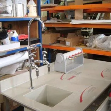 a white sink sitting in a kitchen under a faucet.
