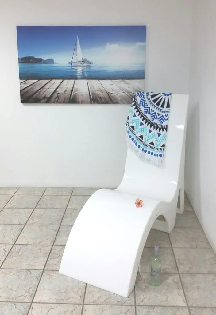a white toilet sitting in a bathroom next to a painting.